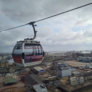 A cable car travels above the city.