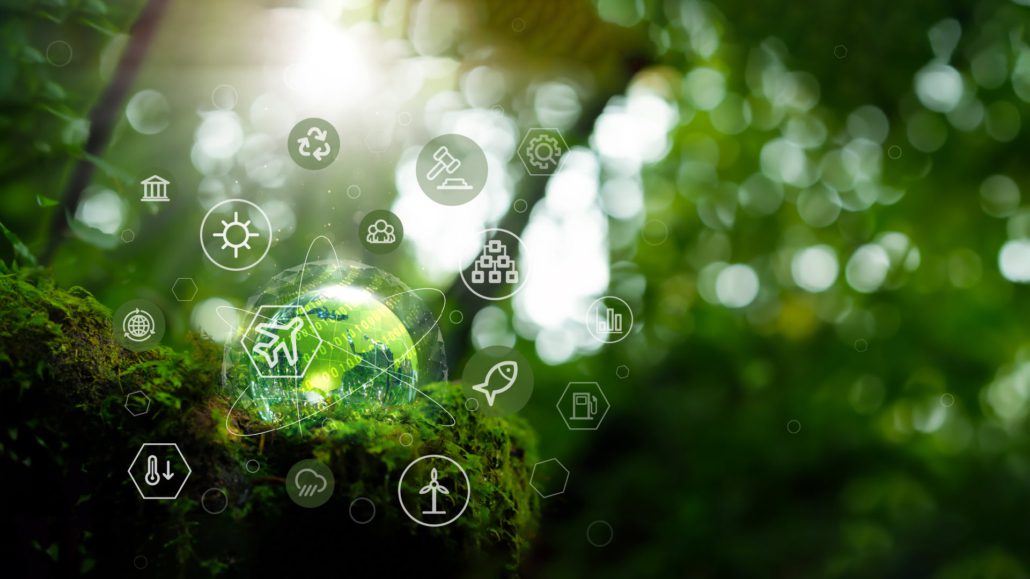 This image features a lush, green forest background with sunlight filtering through leaves, overlaid with icons representing sustainability and environmental technology.