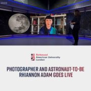 The image shows Richmond American University London student Rhiannon Adam, who is a photographer and aspiring astronaut, going live. Full Text: Richmond American University London PHOTOGRAPHER AND ASTRONAUT-TO-BE RHIANNON ADAM GOES LIVE