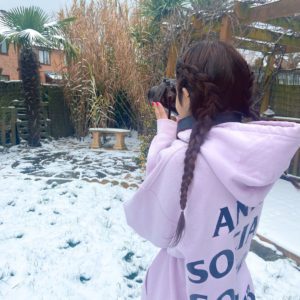 A person is taking a picture in the snow.