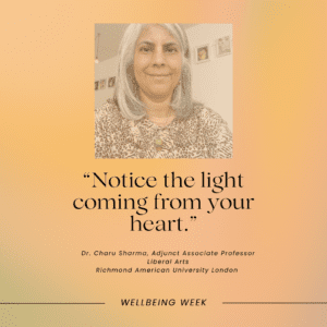 In this image, Dr. Charu Sharma is encouraging viewers to recognize the positive energy coming from within themselves during Wellbeing Week at Richmond American University London.